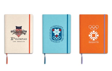 Notebooks with the logos from 1932, 1968, and 1984 Olympics